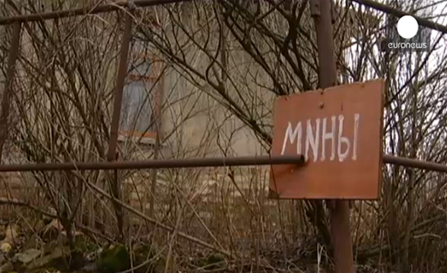 Sign warning about mines in Donbas.
